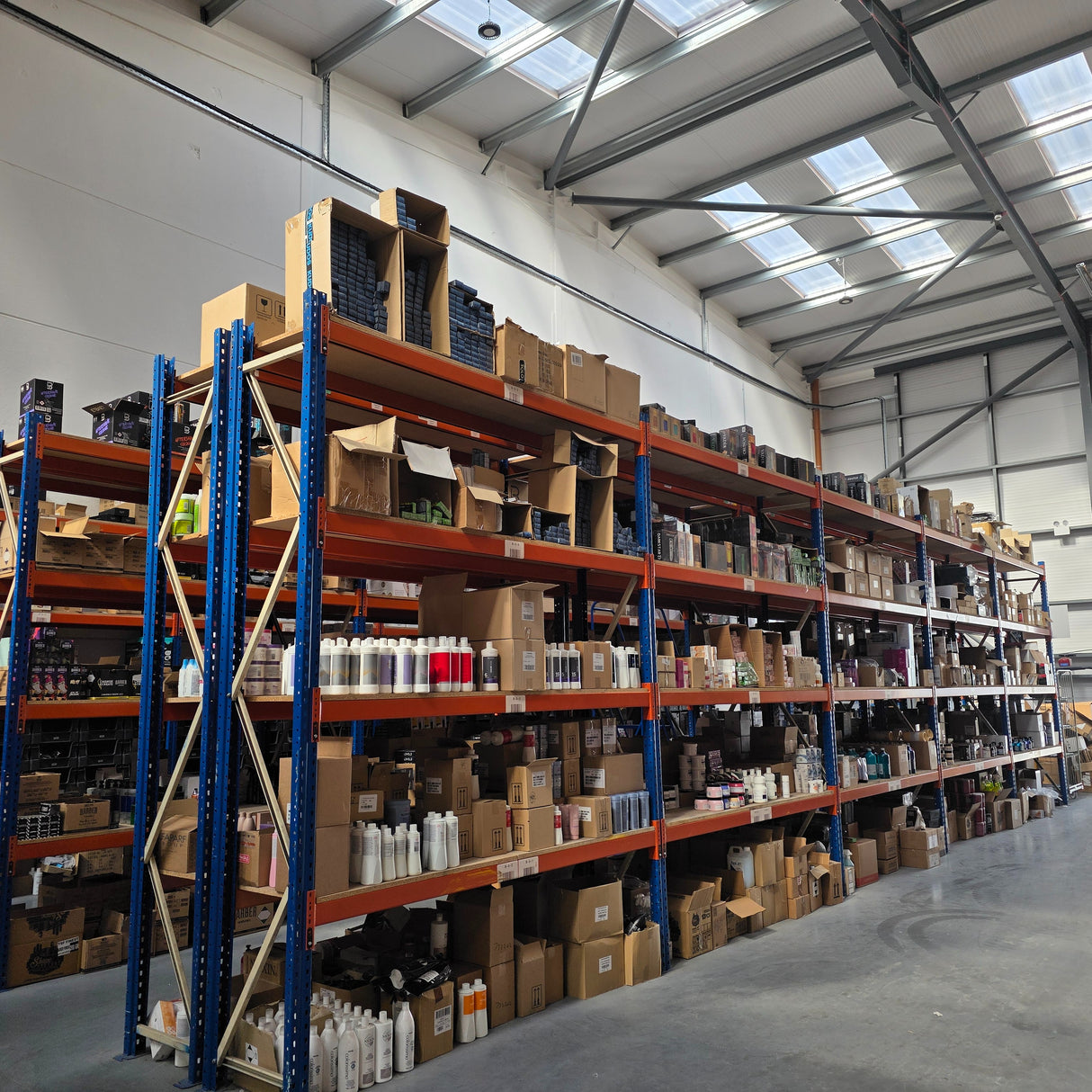 RackZone Longspan Shelving 400mm loaded with boxes and bottles under skylights.