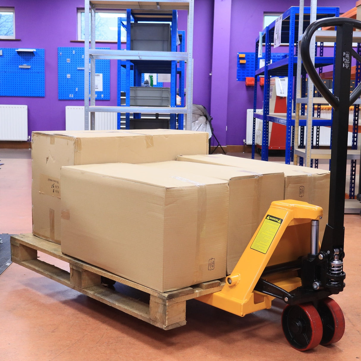 RackZone Pallet Truck 2500kg with PU wheels moves boxes efficiently.