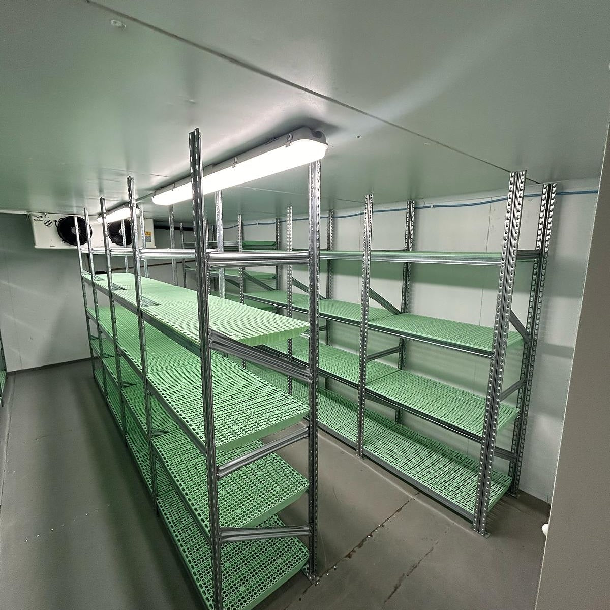 RackZone Galvanised Shelving 500mm with green plastic panels in storage room.