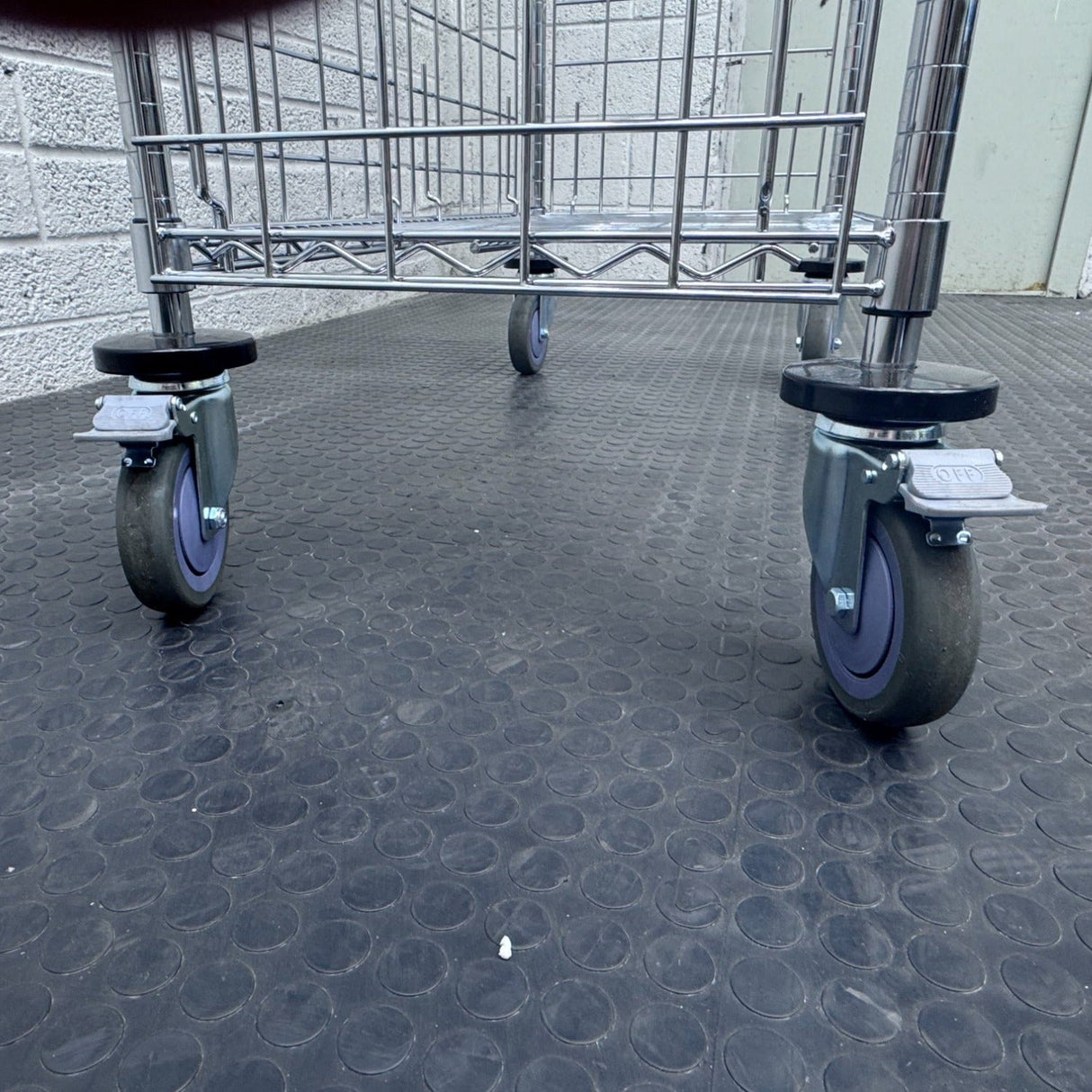 RackZone 4 Tier Chrome plated Trolley with four gray casters on black floor.