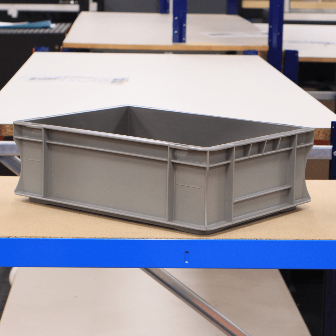 A RackZone Euro Container 400d x 300w x 120h is on a wooden table.