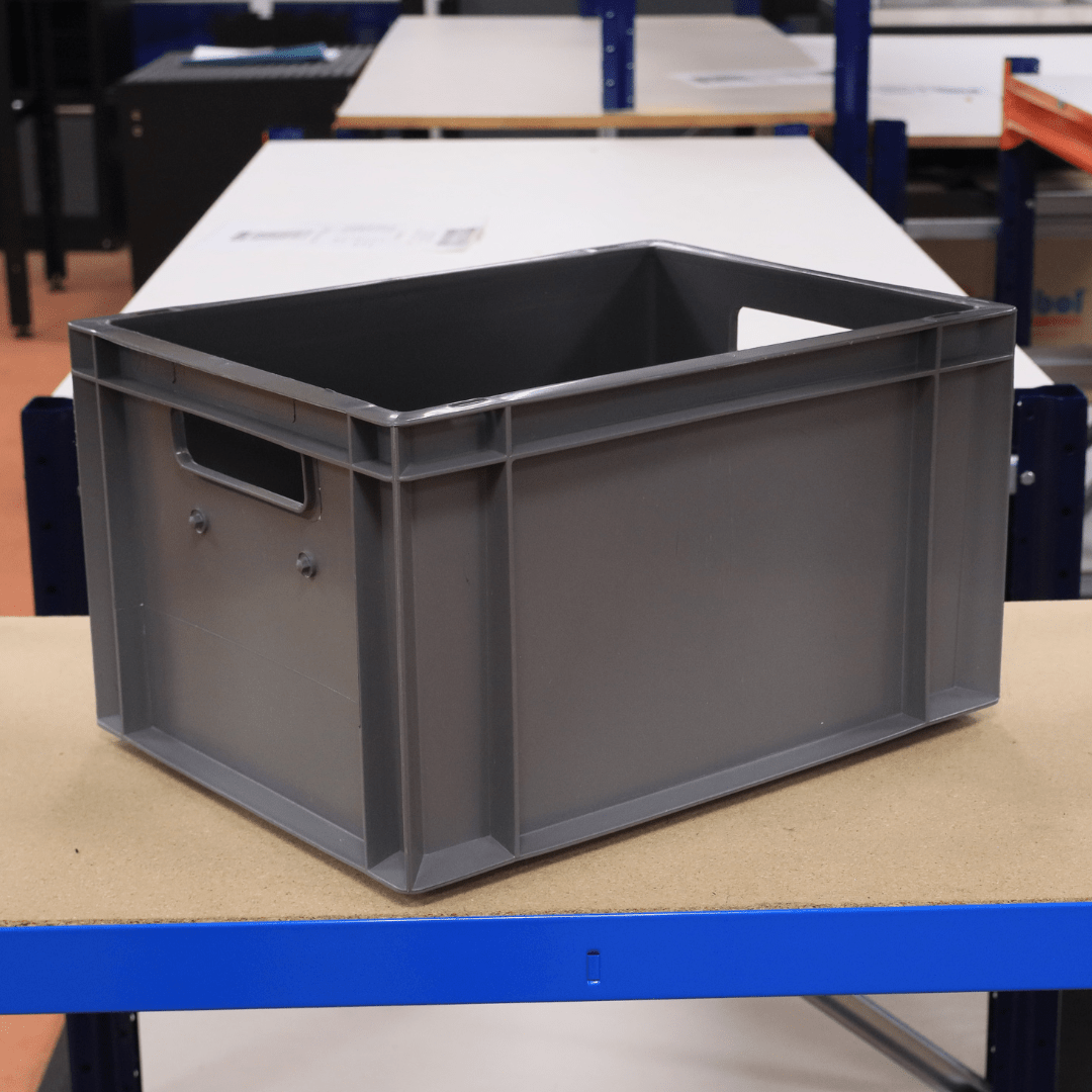 A RackZone Euro Container 400x300x220mm Grey sits on a wooden table.