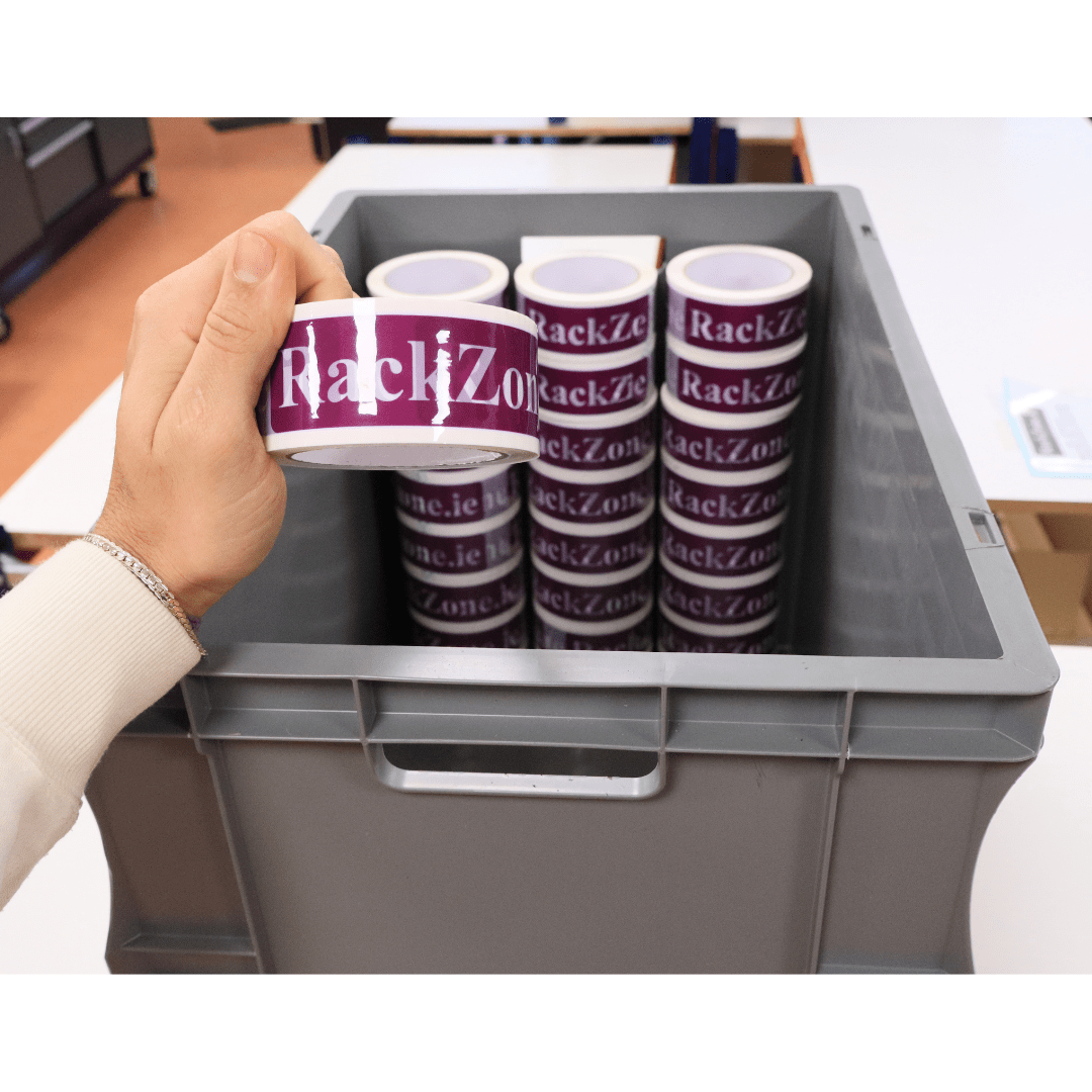 A hand holds RackZone stickers above a Euro Container 600x400x420 Grey.