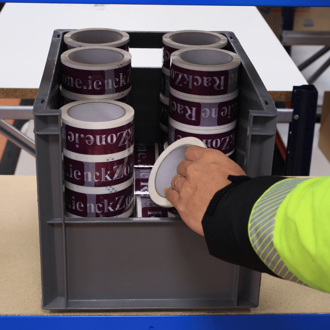 A hand picks up printed tape from a RackZone Euro Picking Container 400x300x290.