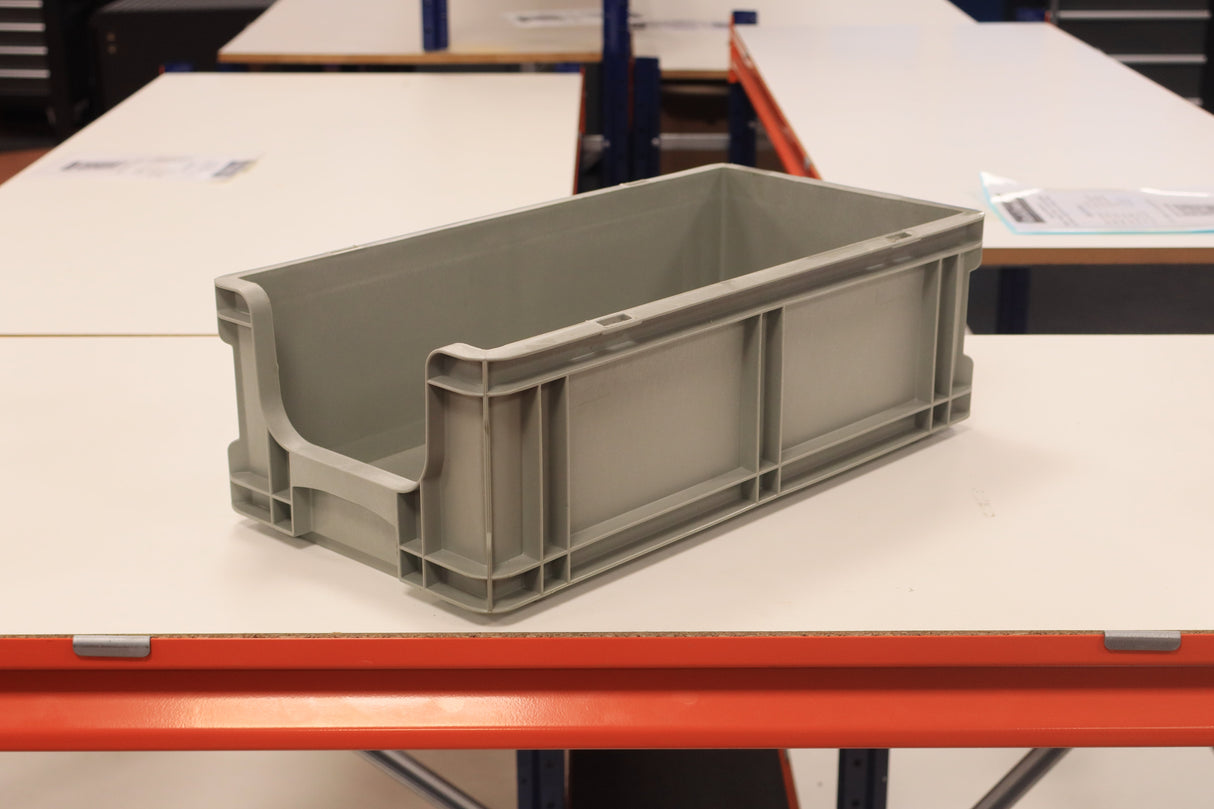 A RackZone grey Euro picking container sits on a white table in a workspace.