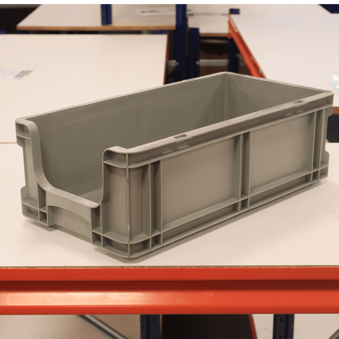 A RackZone Euro Picking Container Grey sits on a white table with orange edges.