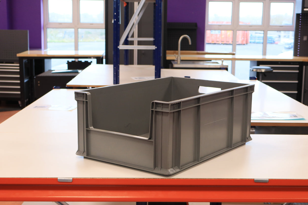 RackZone's 45 grey Euro containers sit on a table in a workshop setting.