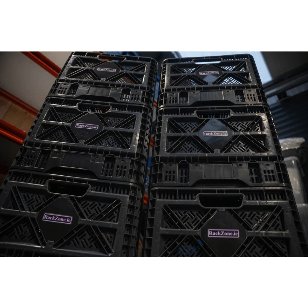 Stacks of RackZone Foldable Crates 25L in grey stored in a warehouse.