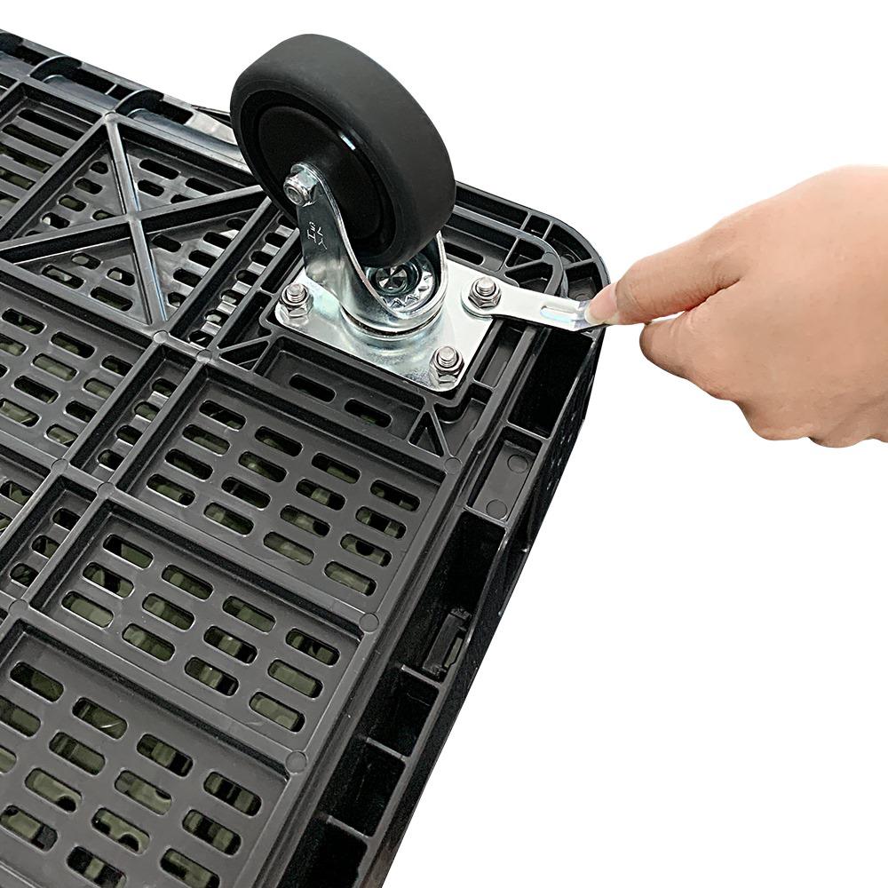 Hand tightening a bolt on a RackZone Foldable Crate Castor Set (x4 castors).