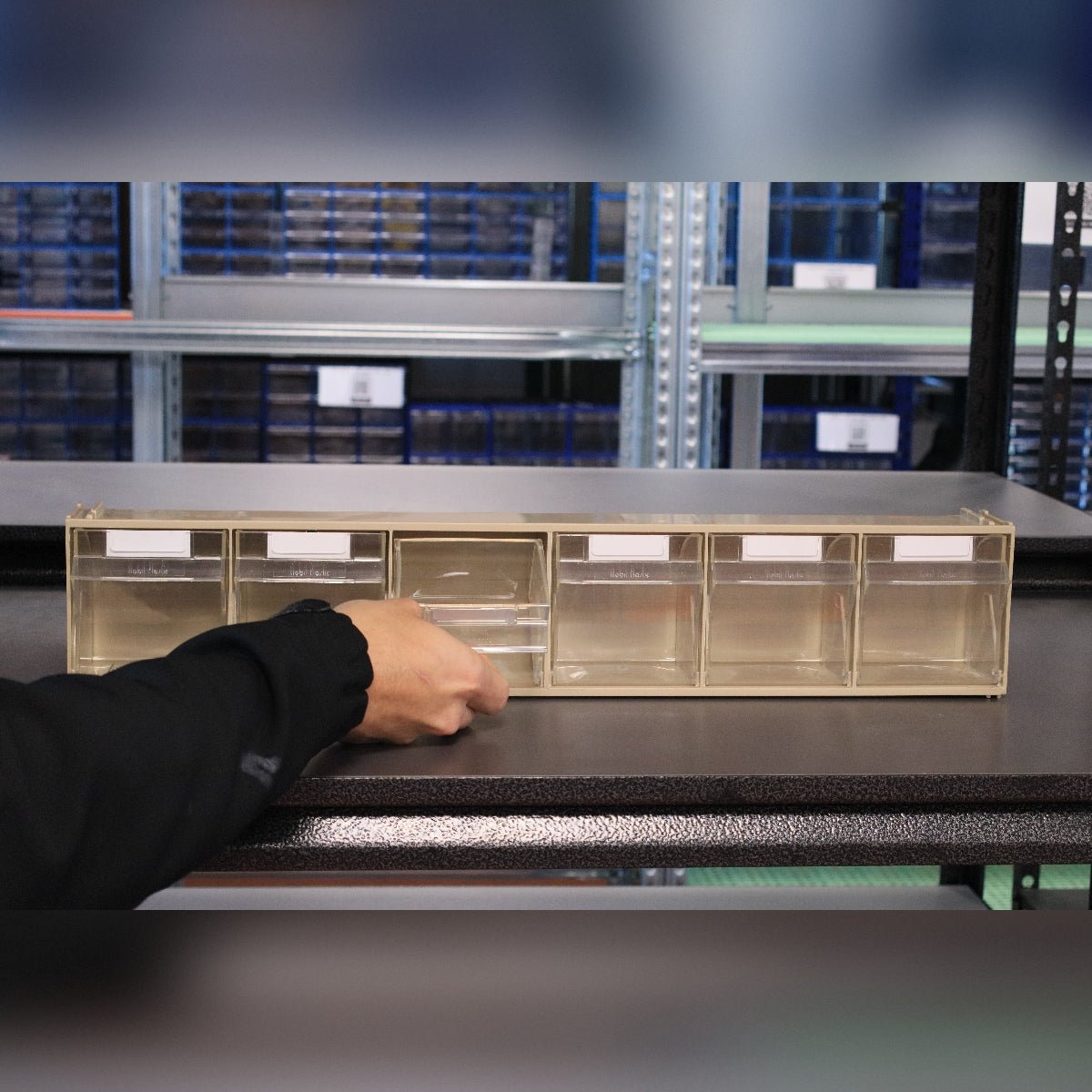 Someone opens a RackZone Storage Tilt Bin Madia 2 (6-Tilt Bin) on a shelf.