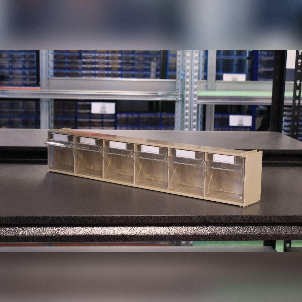 RackZone Storage Tilt Bin Madia 2 (6-Tilt Bin) sits on a shelf in a warehouse.