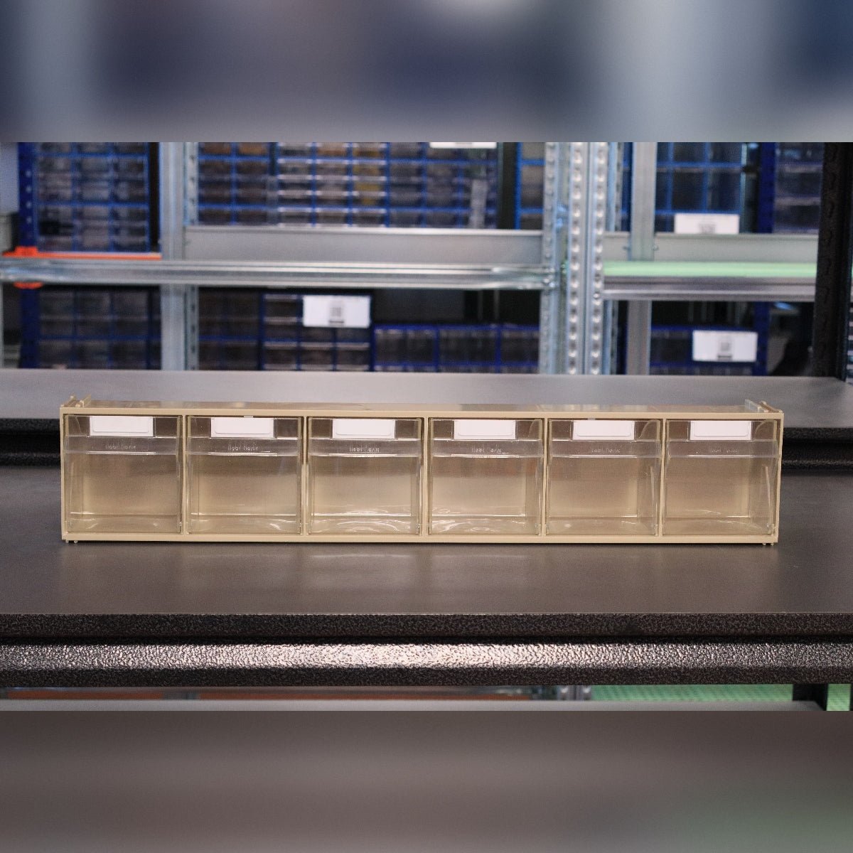 The RackZone 6-Tilt Bin organizer sits on a black table.