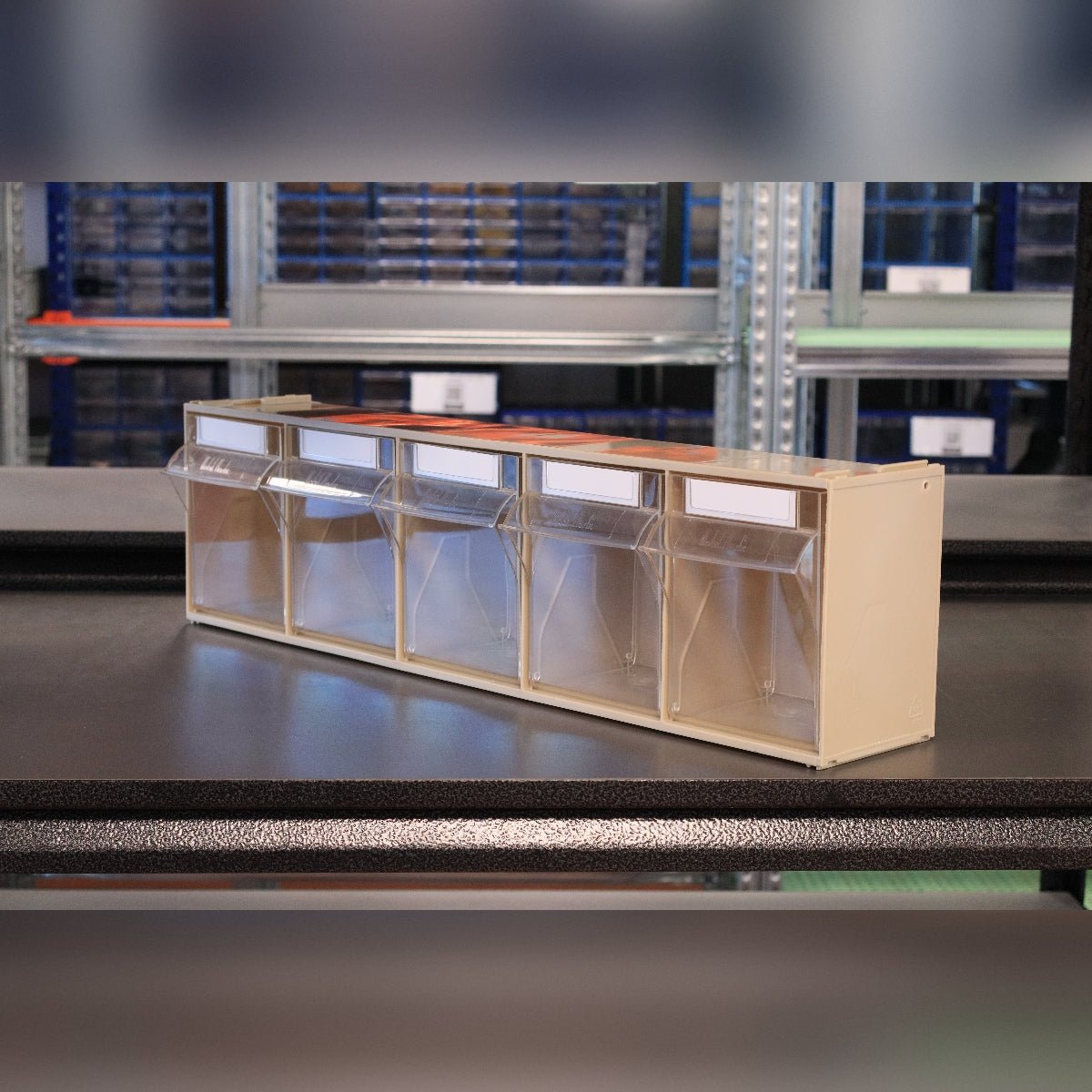 RackZone Storage Tilt Bin Madia 3, beige, 5 clear bins on black table.