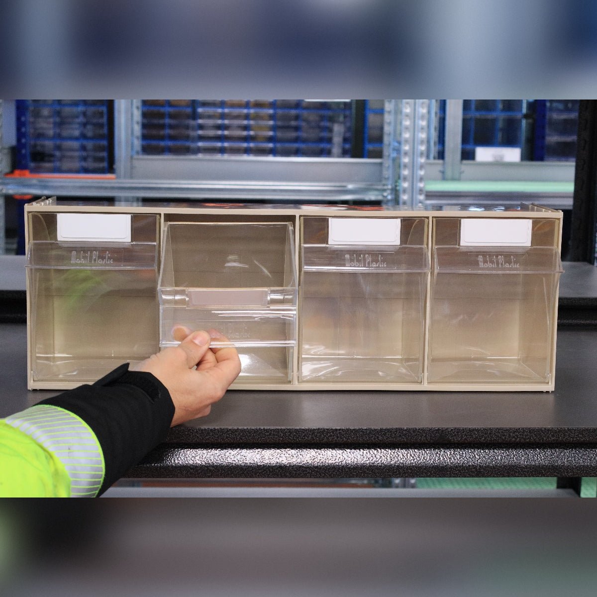 A person opens a compartment of the RackZone 4-Tilt Bin organizer.
