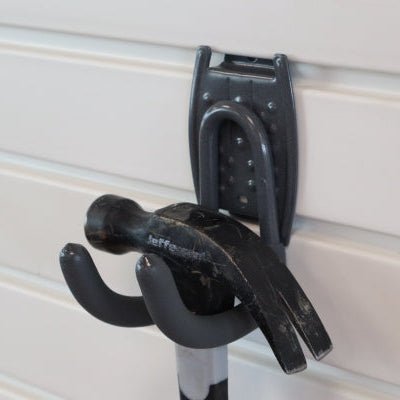 A black hammer hangs on a RackZone Slatwall Work Hook.