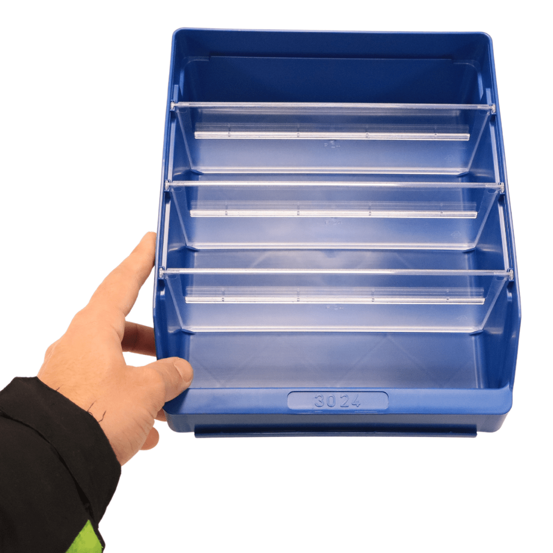 A hand holds a blue RackZone ST3024 shelf bin with three clear dividers.