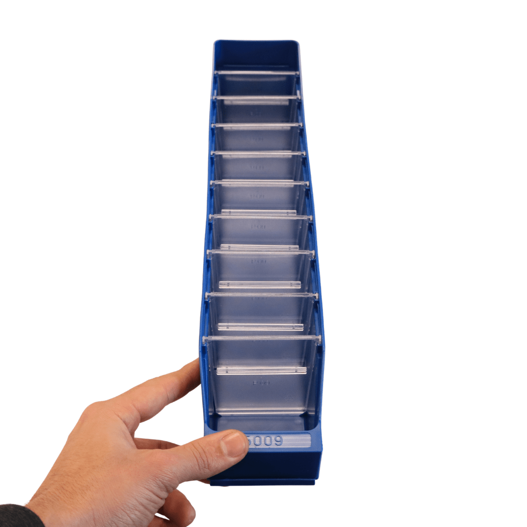 A hand holds a blue RackZone Standard Shelf Bin ST5009 with multiple compartments.
