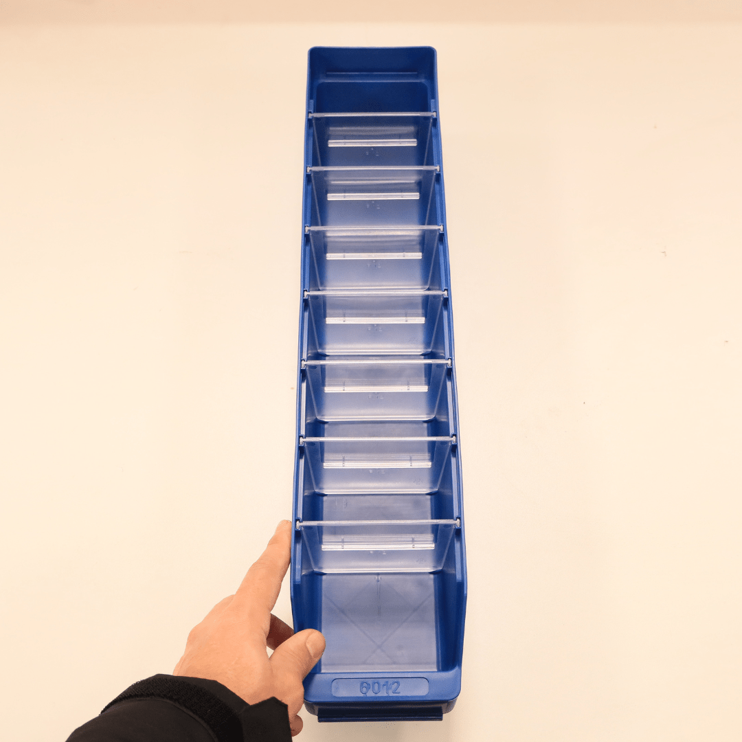 A hand points to a RackZone ST6012 Blue Shelf Bin with clear dividers.
