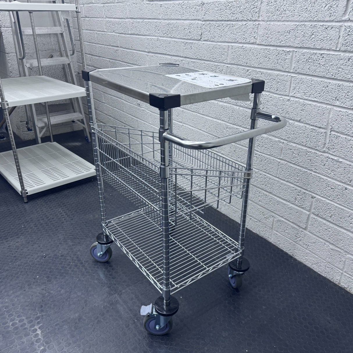 RackZone 3-tier stainless steel/chrome trolley on a black floor.