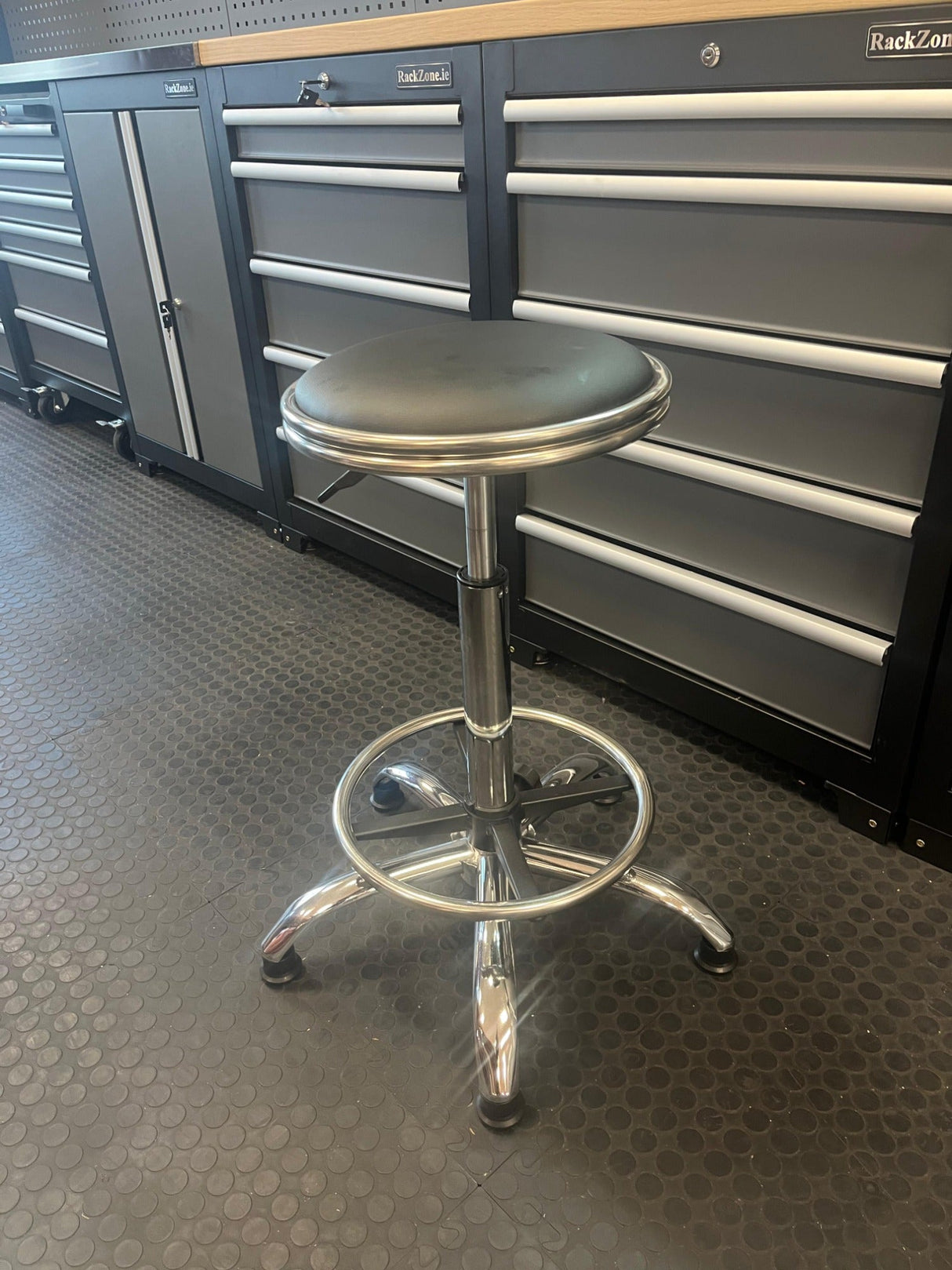 RackZone Modular Workstation Adjustable Stool with round seat on rubber floor.