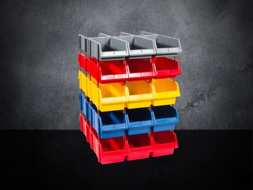 A stack of sixteen plastic storage bins in gray, red, yellow, and blue, arranged in four rows and four columns against a dark background.