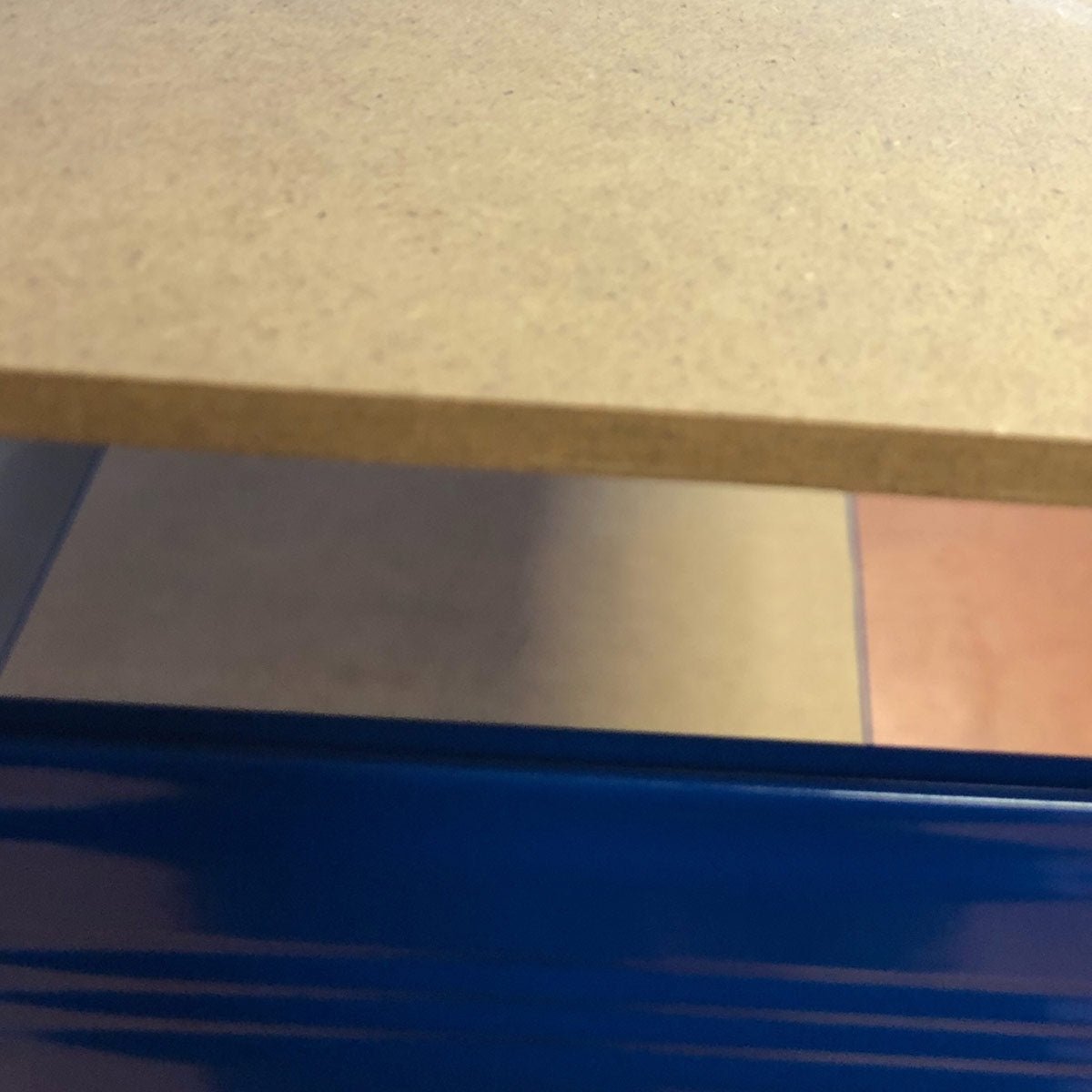 Close-up of RackZone Value Shelving all blue 4-level steel storage unit.