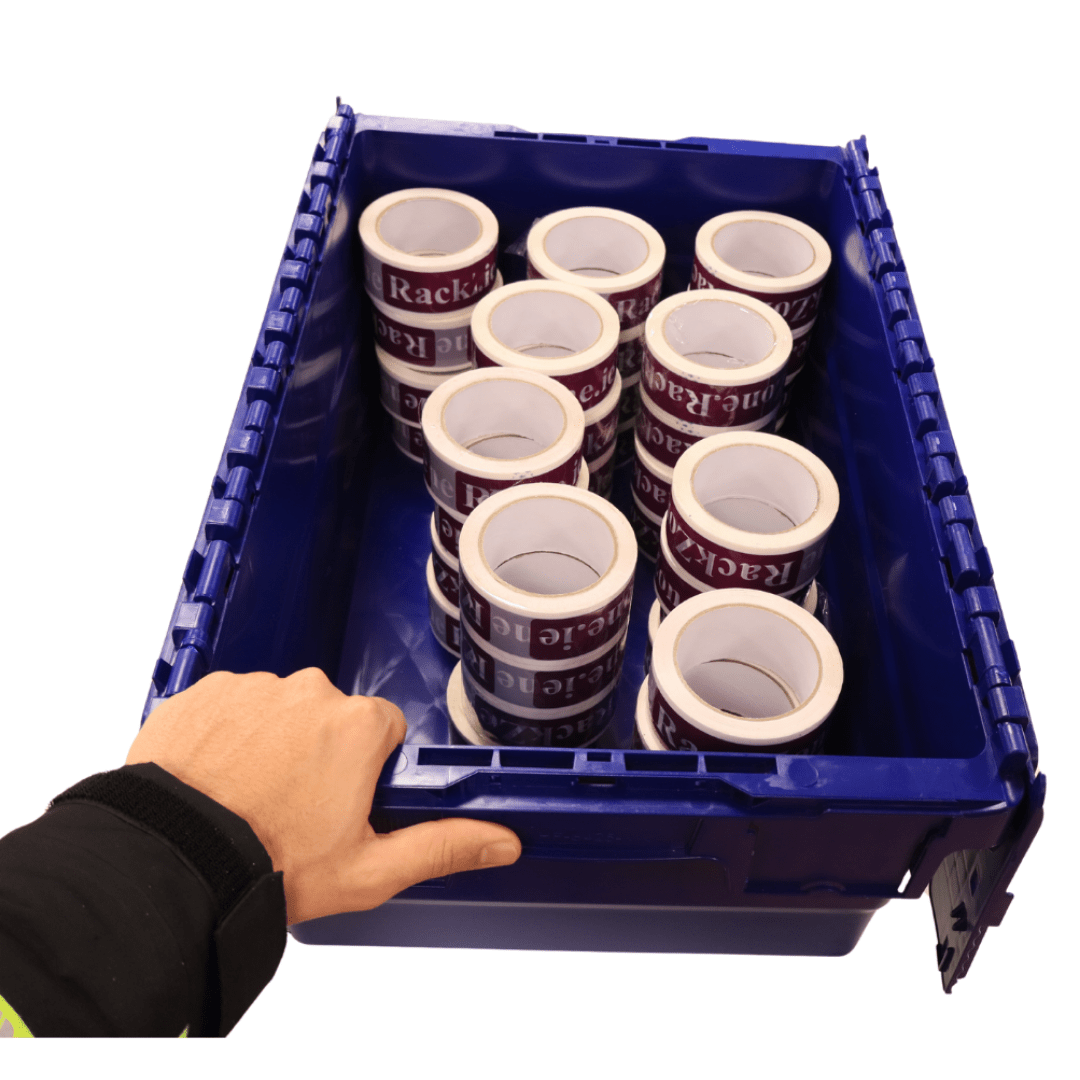 A hand holds a RackZone 44L blue attached lid container with packing tape rolls.