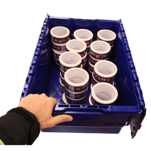 A hand holds a RackZone 44L blue attached lid container with packing tape rolls.
