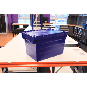 A RackZone 66L blue attached lid container sits on a white table in a workshop.
