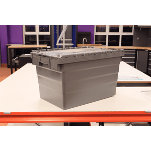 A RackZone 66L grey attached lid container sits on a white table in a workshop.