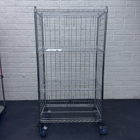 A RackZone 4 Tier Chrome Trolley on wheels stands on a black floor.