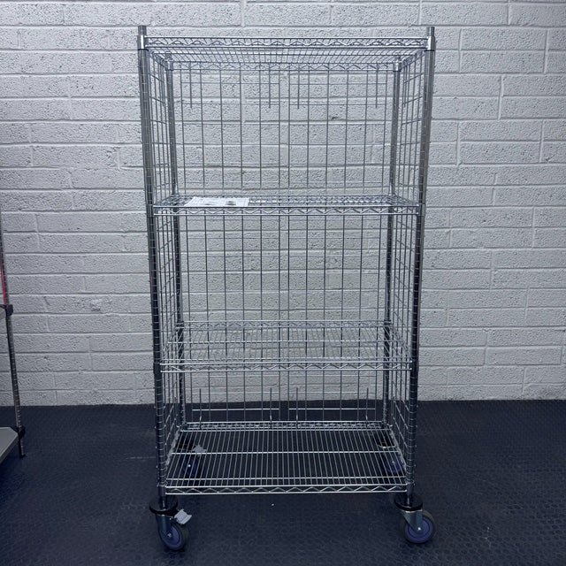 A RackZone 4 Tier Chrome Trolley on wheels stands on a black floor.