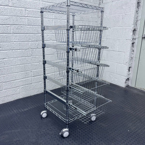 RackZone 5 Tier Chrome Plated Basket Trolley stores items by a gray brick wall.