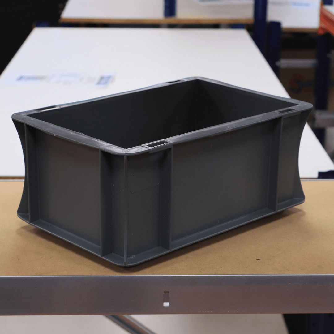 A RackZone Euro Container 200x150x120 Grey sits on a table indoors.