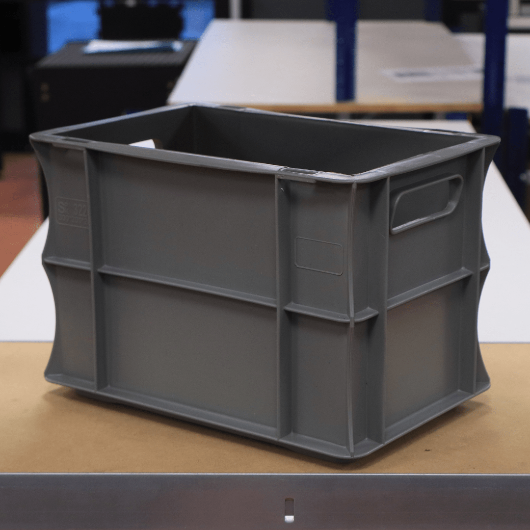 A RackZone Euro Container 300x200x200mm Grey sits on a table indoors.