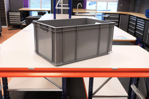 A RackZone Euro Container sits on a white worktable in a workshop.