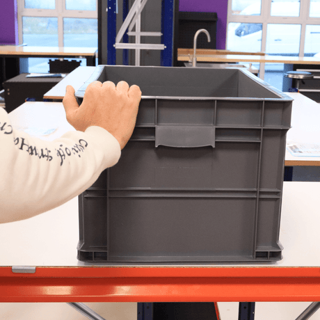 Person places hand on RackZone Euro Container 600x400x320mm Grey.