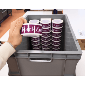 A hand holds RackZone stickers above a Euro Container 600x400x420 Grey.