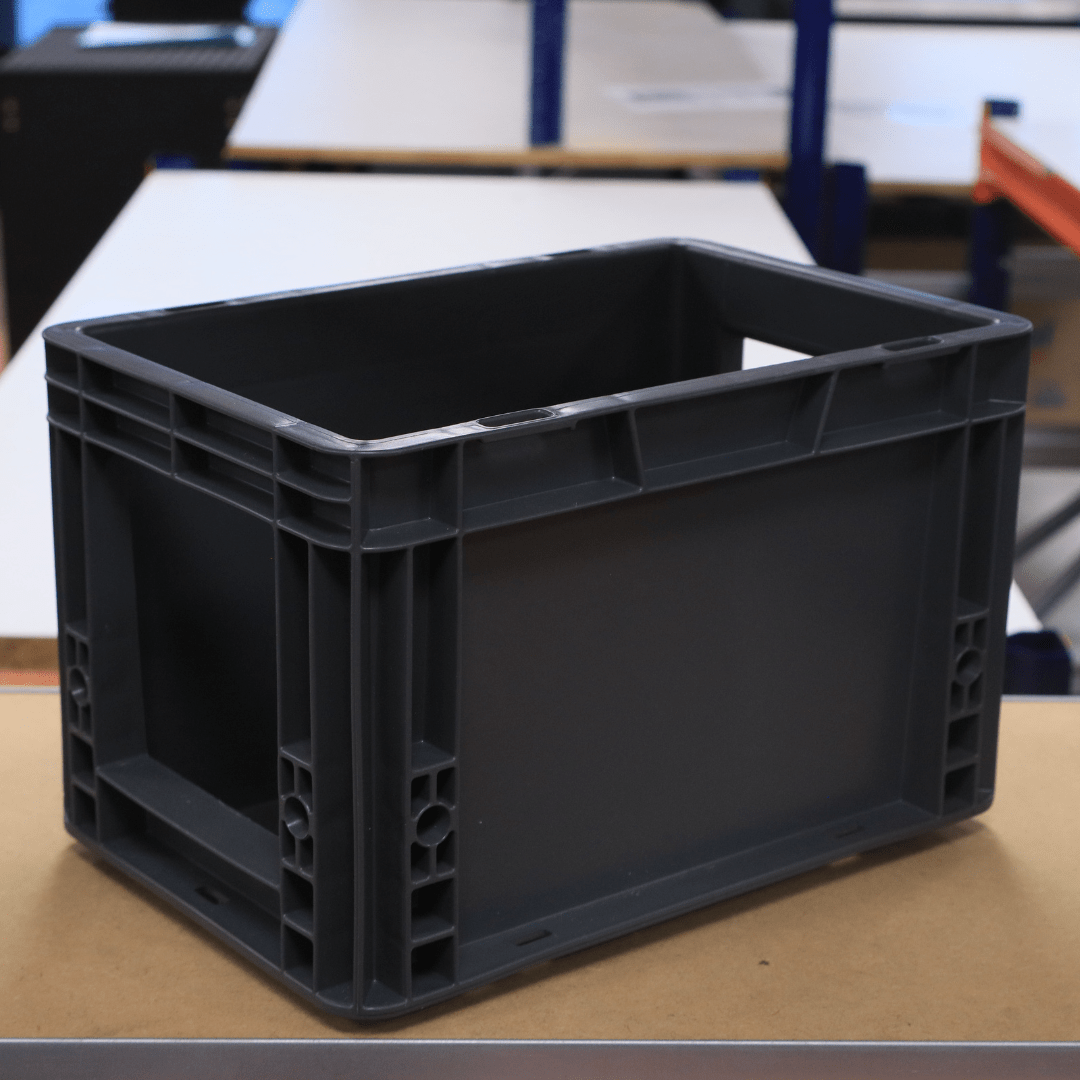 A RackZone Euro Picking Container 300x200x200mm Grey sits on a warehouse table.