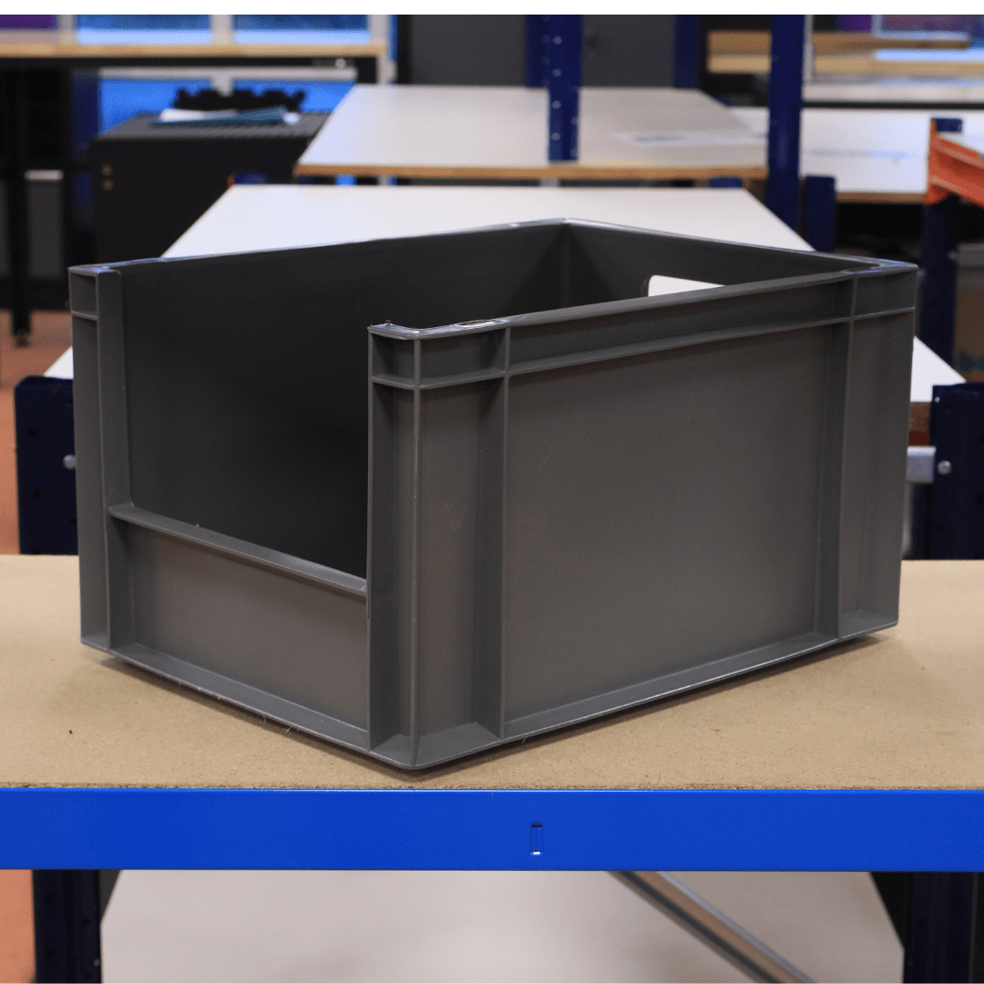A RackZone Euro Picking Container 400x300x220 mm Grey sits on a workshop table.