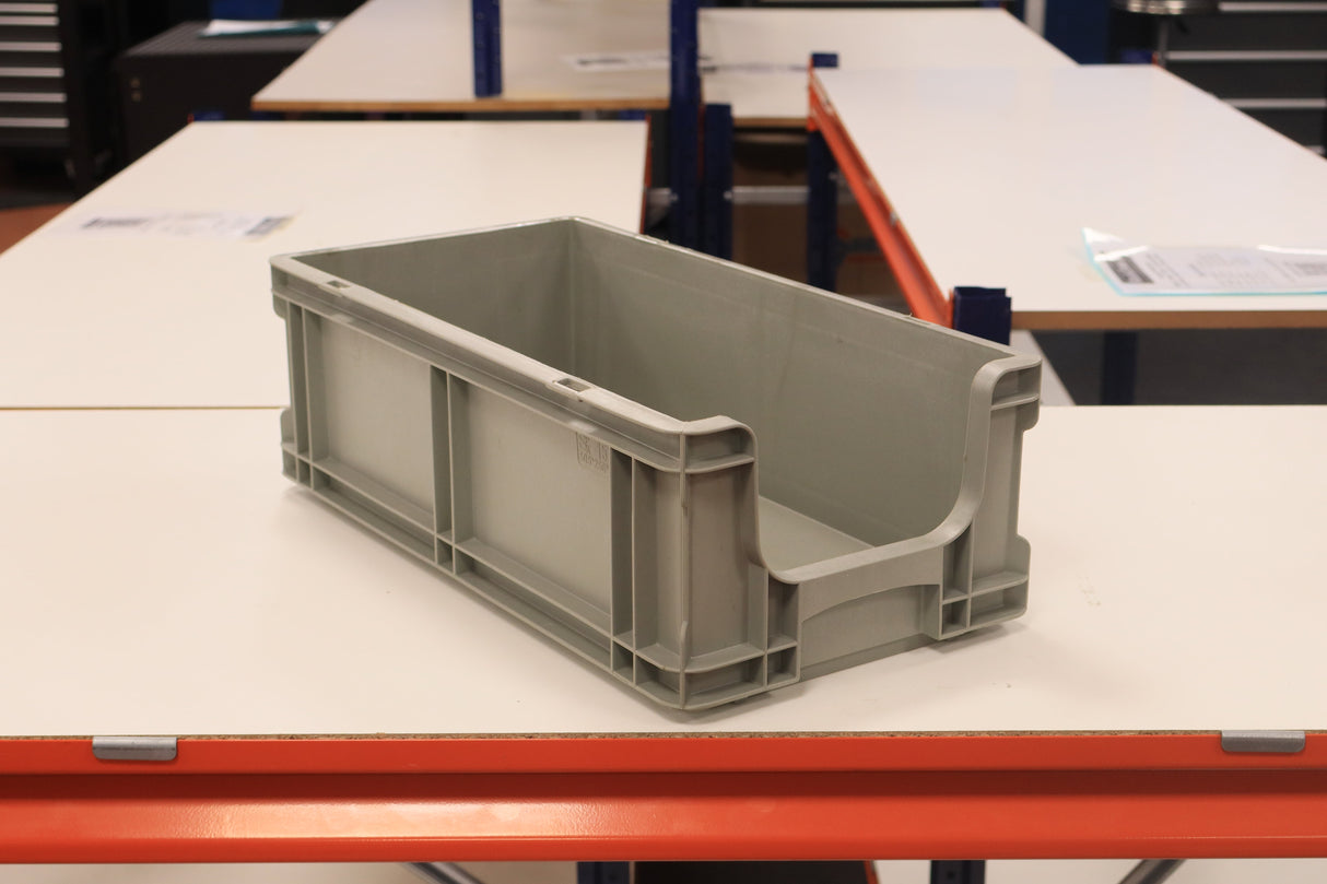 A RackZone grey Euro picking container sits on a white table in a workspace.