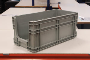 A RackZone grey Euro Picking Container is on a white table in the room.
