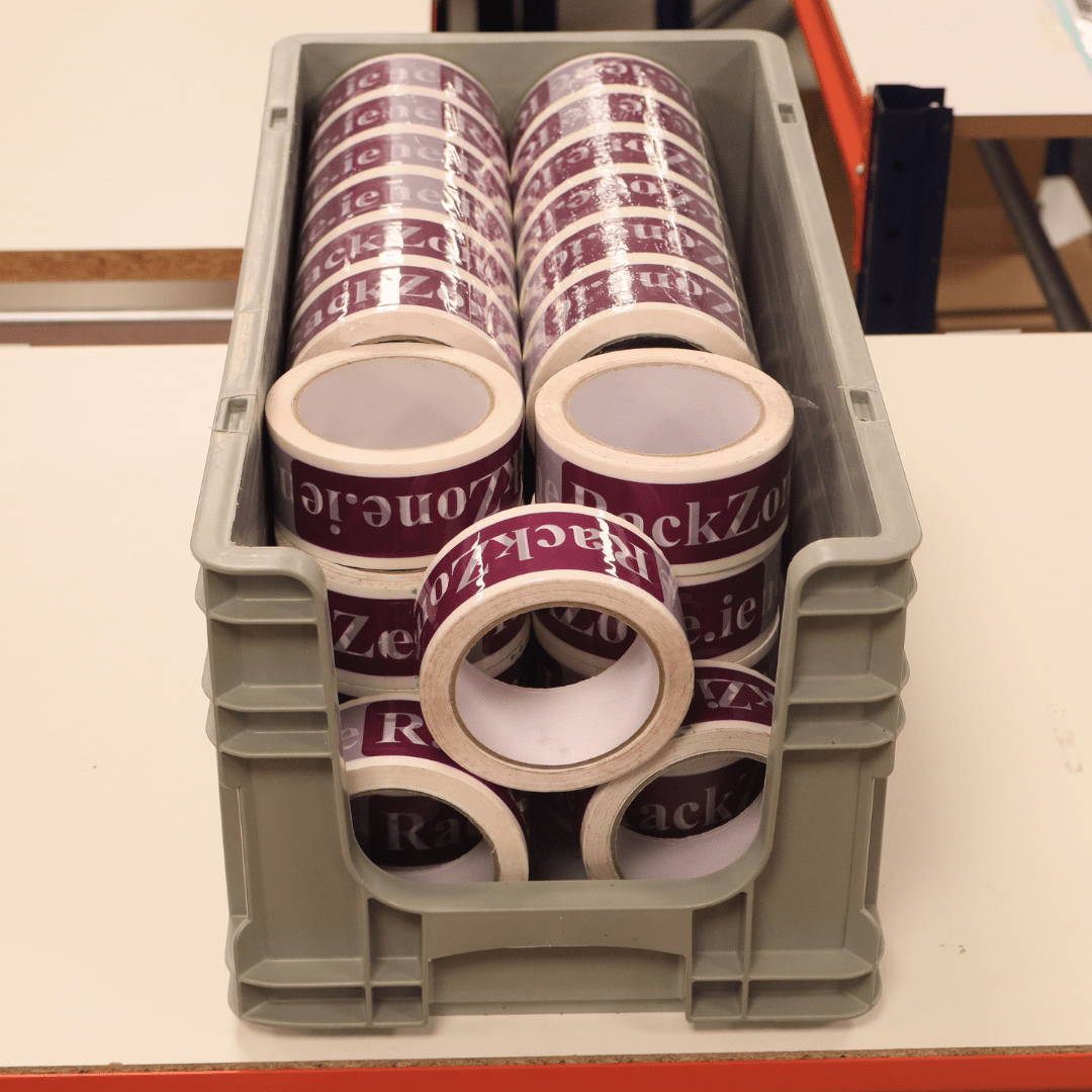 RackZone Euro Picking Container Grey holds rolls of printed purple packing tape.