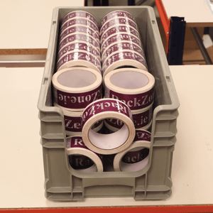 RackZone Euro Picking Container Grey holds rolls of printed purple packing tape.
