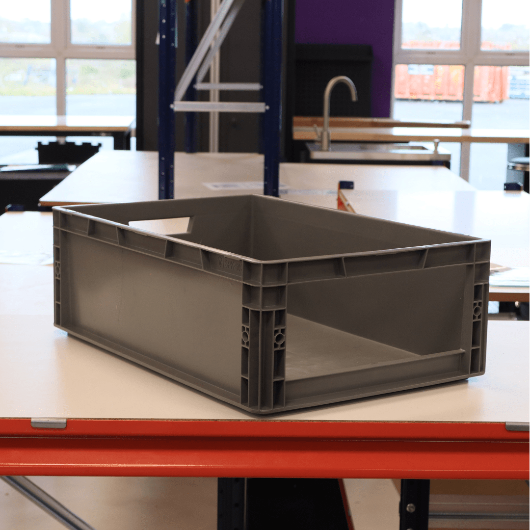 A RackZone Euro Picking Container 600x400x200mm sits on a table in a workspace.