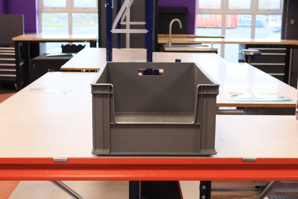 A RackZone Euro Picking Container sits on a white worktable in a workshop.