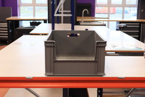A RackZone Euro Picking Container sits on a white worktable in a workshop.
