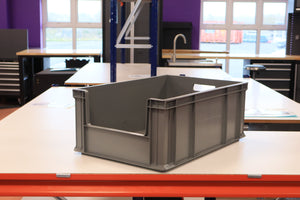RackZone's 45 grey Euro containers sit on a table in a workshop setting.