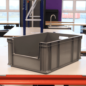 A RackZone Euro Picking Container 600x400x230 Grey sits on a workshop table.