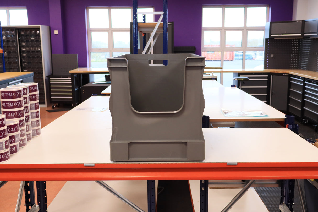 A RackZone grey Euro Picking Container sits on a white workbench in a workshop.